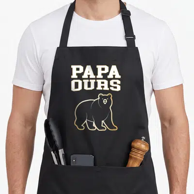 Tablier de cuisine noir avec inscription PAPA OURS et silhouette d'ours aux contours dorés sur fond uni.