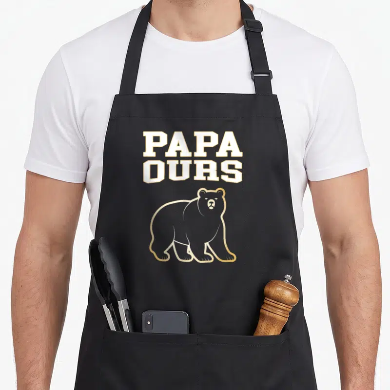 Tablier de cuisine noir avec inscription PAPA OURS et silhouette d'ours aux contours dorés sur fond uni.