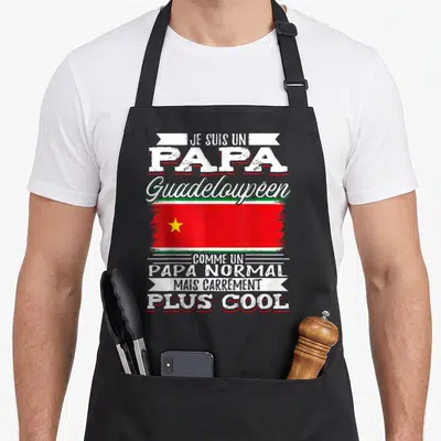 Tablier de cuisine noir avec texte blanc et drapeau rouge vert à étoile jaune centré sur la poitrine.