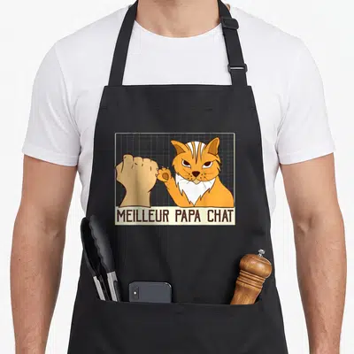Tablier de cuisine noir avec illustration d'un chat orange et d'une main effectuant un poing contre poing.