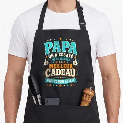 Tablier de cuisine noir avec typographie colorée et texte humoristique dédié aux papas.