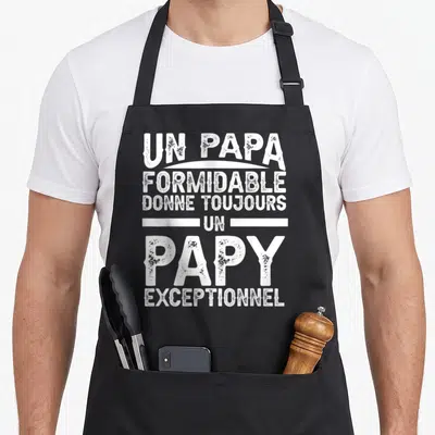 Tablier de cuisine noir avec inscription blanche Un Papa Formidable Donne Toujours Un Papy Exceptionnel en typographie texturée.
