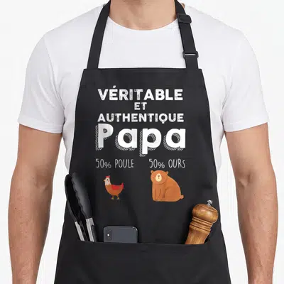 Tablier de cuisine noir avec l'inscription Véritable et Authentique Papa 50% Poule 50% Ours illustrée par une poule et un ours.