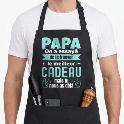 Tablier de cuisine noir avec texte bleu et blanc Papa Cadeau et deux pouces levés stylisés.