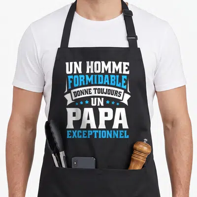 Tablier de cuisine noir avec l'inscription Un homme formidable donne toujours un papa exceptionnel en blanc et bleu.