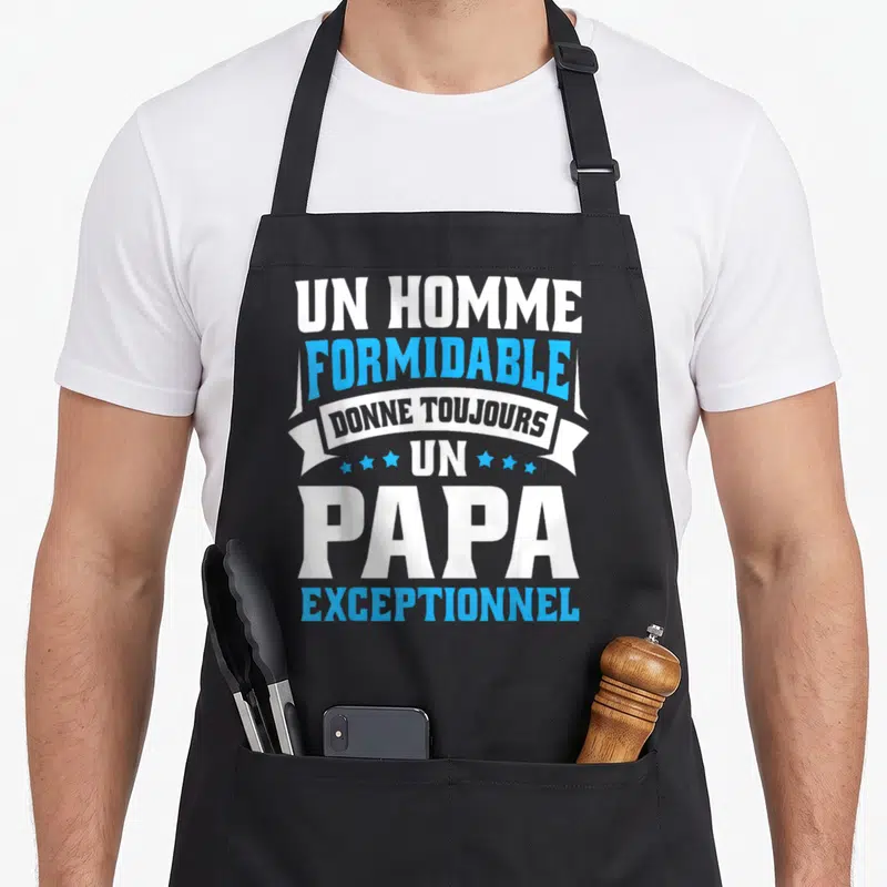 Tablier de cuisine noir avec l'inscription Un homme formidable donne toujours un papa exceptionnel en blanc et bleu.