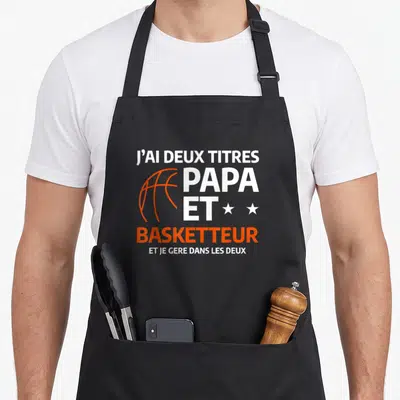 Tablier de cuisine noir avec texte blanc et orange J'ai deux titres papa et basketteur.
