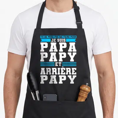 Tablier de cuisine noir avec inscription blanche et bleue Je suis Papa Papy et Arrière Papy sur fond uni.