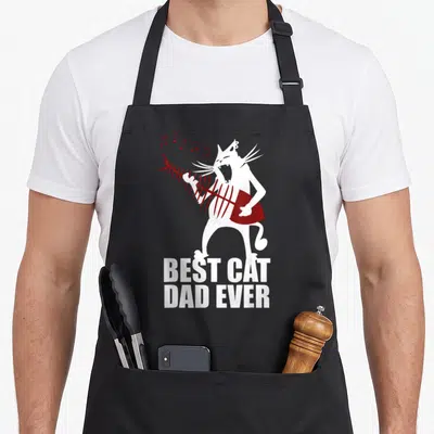 Tablier de cuisine noir avec un chat blanc jouant d'une guitare en arêtes de poisson et le texte Best Cat Dad Ever en bas.