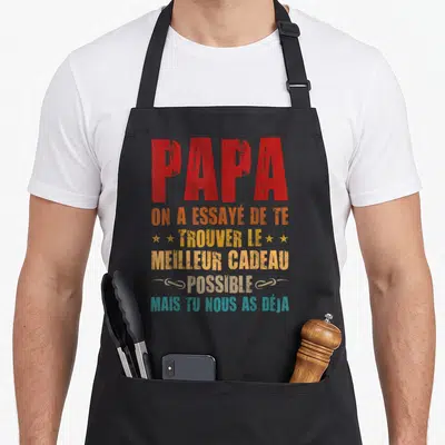 Tablier de cuisine noir avec inscription rouge et multicolore rendant hommage à un papa comblé par ses enfants.