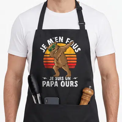 Tablier de cuisine noir avec un ours effectuant un dab et le texte Je m'en fous je suis un papa ours.