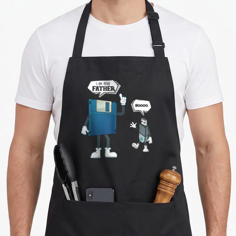 Tablier de cuisine noir avec une disquette bleue et une clé USB grise en personnages animés.