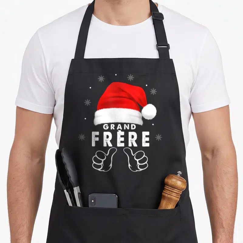 Tablier de cuisine noir orné d'un bonnet rouge, du texte Grand Frère et deux mains blanches en signe d'approbation.