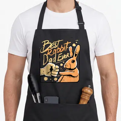 Tablier de cuisine noir avec illustration d'un lapin orange et d'une main effectuant un poing, texte Best Rabbit Dad Ever.