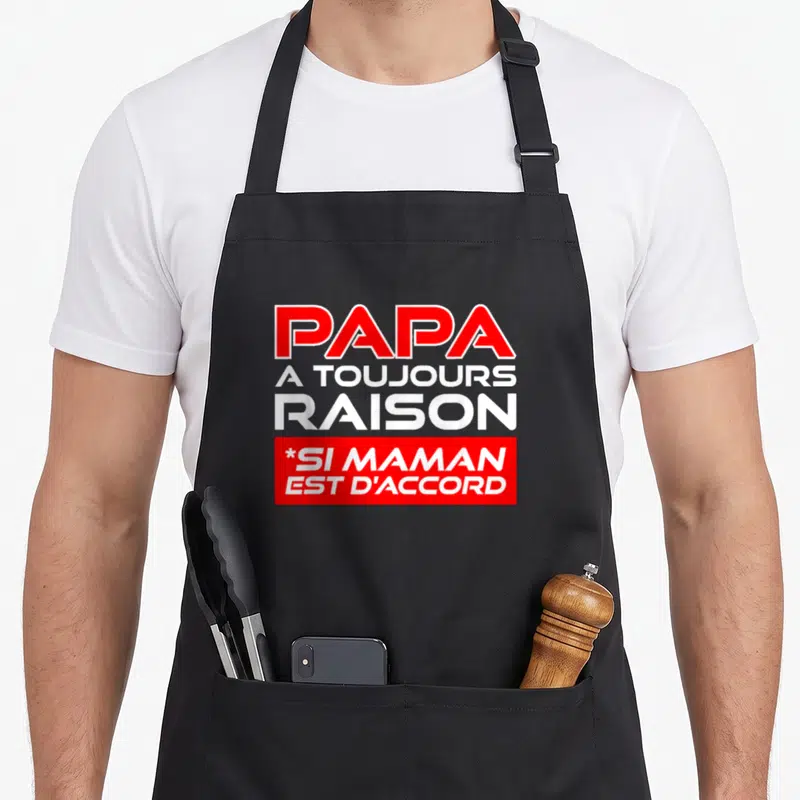 Tablier de cuisine noir avec l'inscription Papa a toujours raison si maman est d'accord en lettres rouges et blanches.