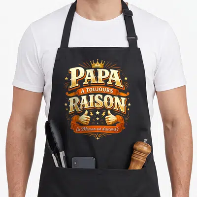 Tablier de cuisine noir avec linscription Papa a toujours raison sur fond orange et jaune.