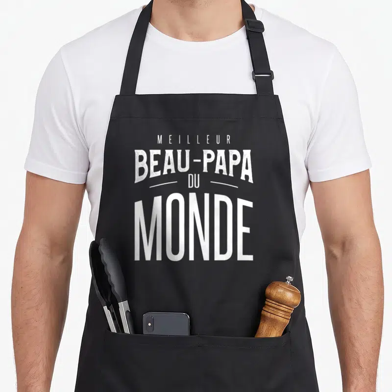 Tablier de cuisine noir avec l'inscription Meilleur Beau-Papa Du Monde en lettres blanches stylisées au centre.