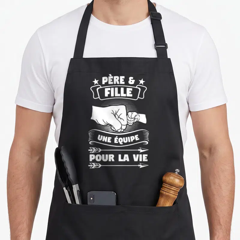 Tablier de cuisine noir avec inscription Père et Fille une équipe pour la vie et illustration de poings qui se serrent.