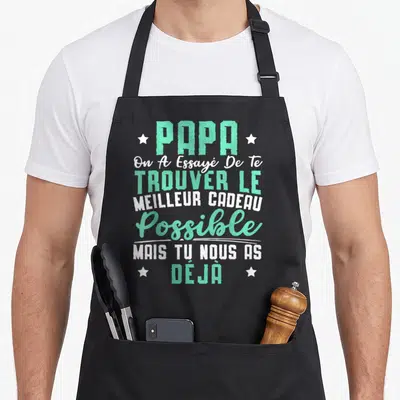 Tablier de cuisine noir avec inscription typographique Papa On A Essayé De Te Trouver Le Meilleur Cadeau Possible en vert et blanc.