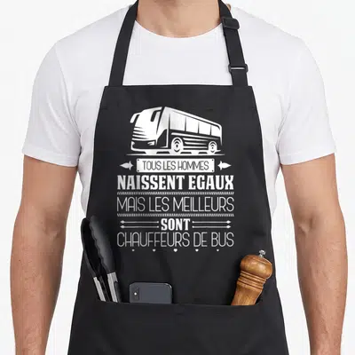 Tablier de cuisine noir avec illustration d'autocar blanc et texte humoristique sur les chauffeurs de bus