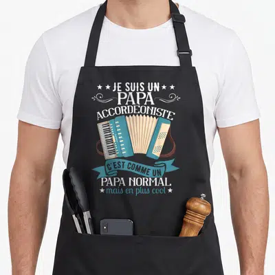 Tablier de cuisine noir avec illustration d'accordéon bleu et texte blanc Je suis un papa accordeoniste mais en plus cool.