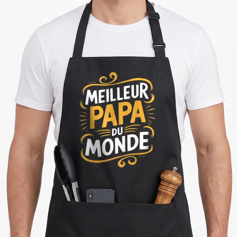 Tablier de cuisine noir avec l'inscription Meilleur Papa du Monde en blanc et jaune.