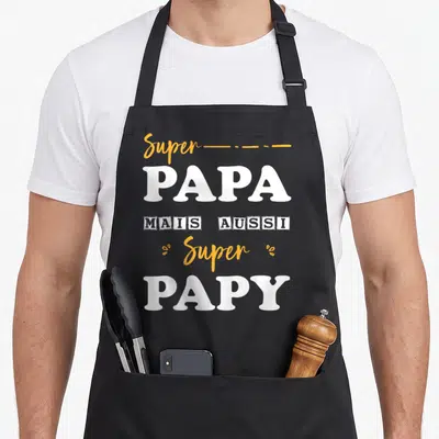 Tablier de cuisine noir avec inscription Super Papa mais aussi Super Papy en blanc et orange