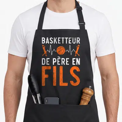 Tablier de cuisine noir avec inscription Basketteur De Père En Fils et silhouette orange de joueurs de basketball.