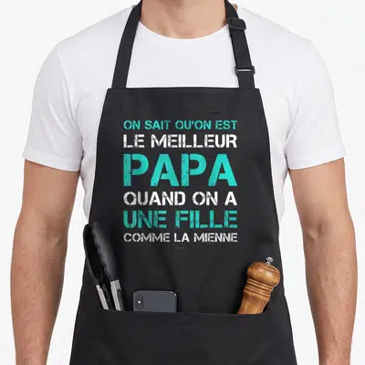 Tablier de cuisine noir avec inscription blanche et turquoise sur fond gris