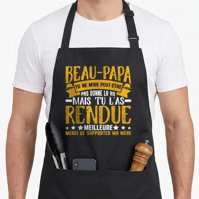 Tablier de cuisine noir avec typographie jaune et blanche remerciant un beau-papa pour son soutien.