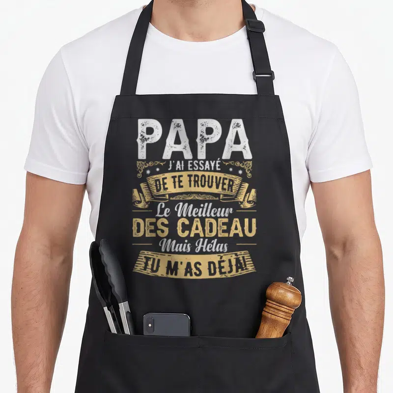 Tablier de cuisine noir avec typographie vintage blanche et dorée citant Papa et les cadeaux.