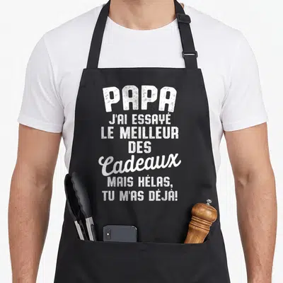 Tablier de cuisine noir avec inscription blanche humoristique dédiée aux pères affectueux et attentionnés.