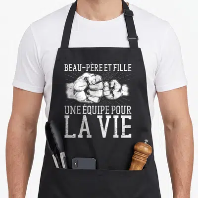 Tablier de cuisine noir avec illustration blanche de deux poings se touchant et texte vintage en haut et en bas.