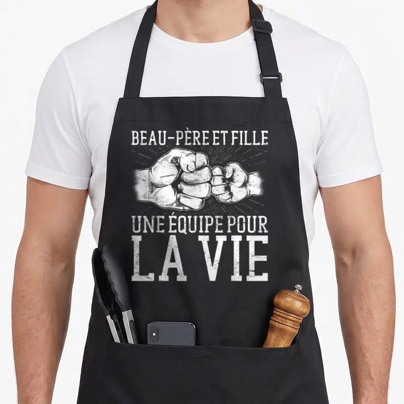 Tablier de cuisine noir avec illustration blanche de deux poings se touchant et texte vintage en haut et en bas.