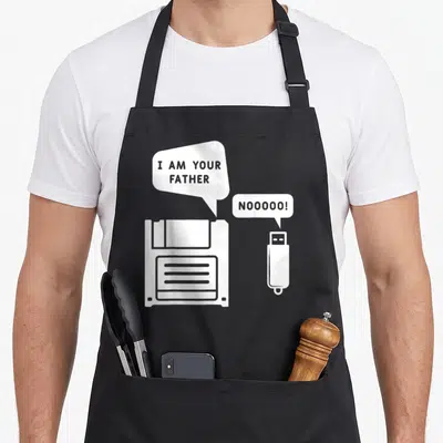 Tablier de cuisine noir avec illustration d'une disquette et d'une clé USB en blanc sur fond uni.