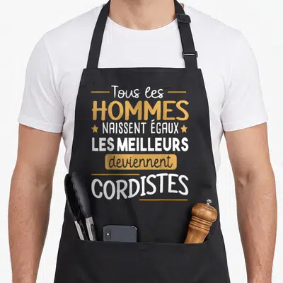 Tablier de cuisine noir avec le texte Tous les hommes naissent égaux les meilleurs deviennent cordistes en blanc et orange.
