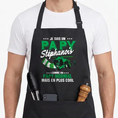 Tablier de cuisine noir avec un léopard vert, un foulard blanc et vert, et le texte Je suis un papy Stéphaneois comme un papy normal mais en plus cool.
