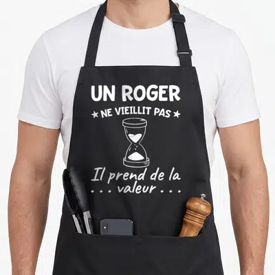 Tablier de cuisine noir avec inscription Un Roger ne vieillit pas il prend de la valeur et illustration de sablier blanc.