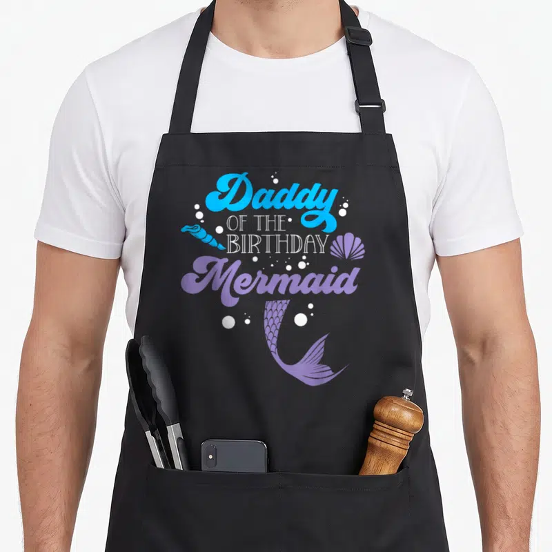 Tablier de cuisine noir avec inscription Daddy of the anniversaire Mermaid et queue de sirène violette.