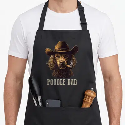 Tablier de cuisine noir avec illustration d'un caniche au chapeau et cigare, texte POODLE DAD en bas.