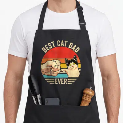Tablier de cuisine noir avec illustration vintage Best Cat Dad Ever et poing de chat.