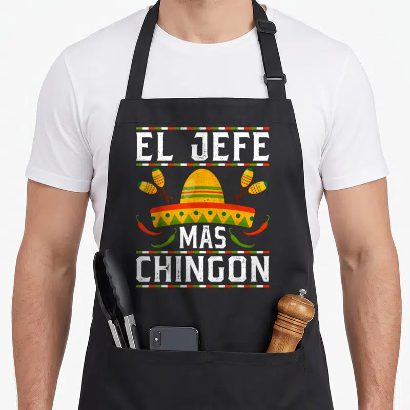 Tablier de cuisine noir avec un sombrero jaune, des maracas et le texte El Jefe Mas Chingon en lettres blanches.