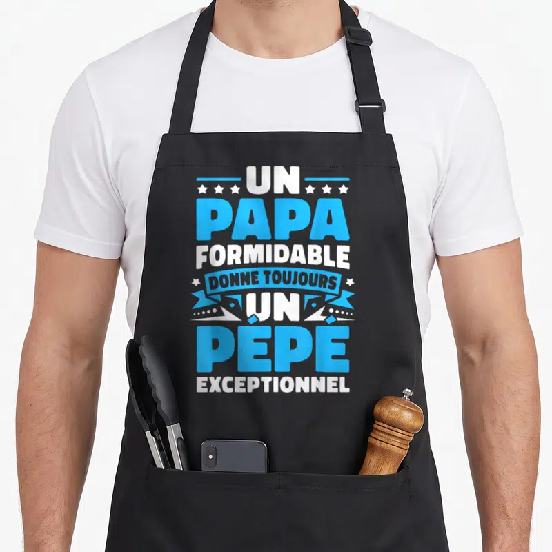 Tablier de cuisine noir avec inscription Un Papa Formidable Donne Toujours Un Pépé Exceptionnel en bleu et blanc.