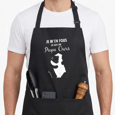 Tablier de cuisine noir avec l'inscription Je m'en fous je suis un papa ours et une illustration d'ours blanc.