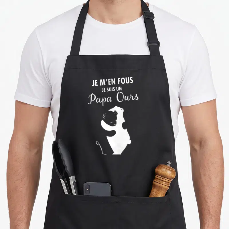 Tablier de cuisine noir avec l'inscription Je m'en fous je suis un papa ours et une illustration d'ours blanc.