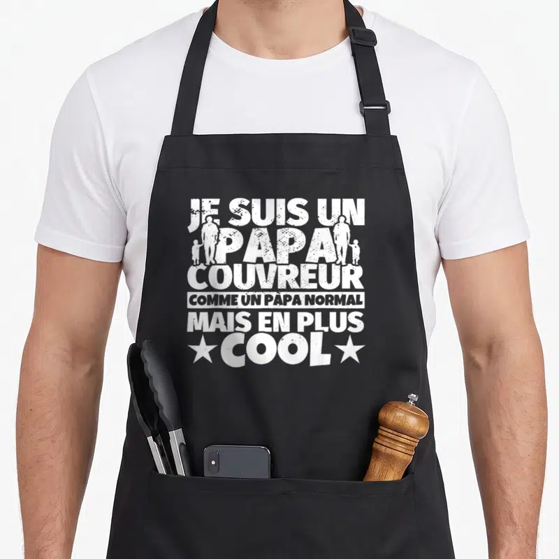 Tablier de cuisine noir avec inscription blanche Je suis un papa couvreur et silhouettes d'hommes tenant la main d'enfants.