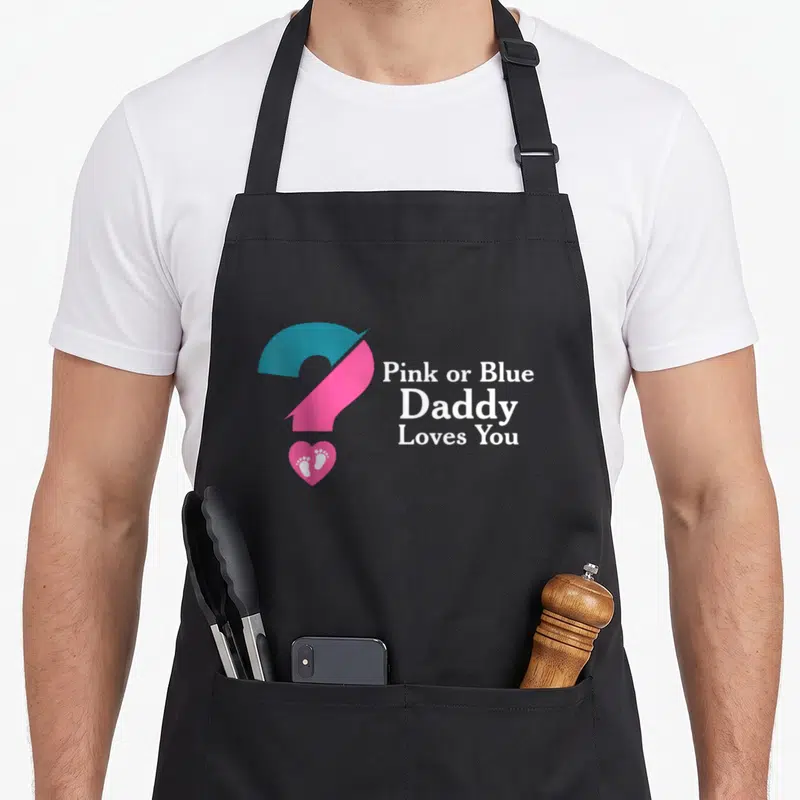 Tablier de cuisine noir avec grand point d'interrogation bicolore rose et bleu et texte blanc Daddy Loves You.