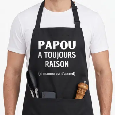 Tablier de cuisine noir avec l'inscription blanche Papou a toujours raison si mamou est d'accord.