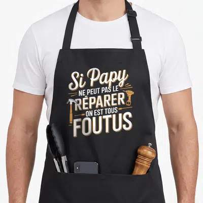 Tablier de cuisine noir avec inscription blanche et orange Si Papy ne peut pas le réparer on est tous foutus entourée d'un marteau et une perceuse.