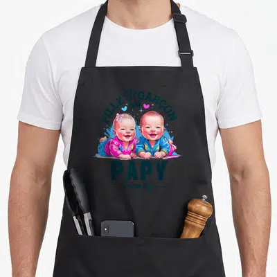 Tablier de cuisine noir avec illustration de deux bébés et le texte Papy t'aime déjà.